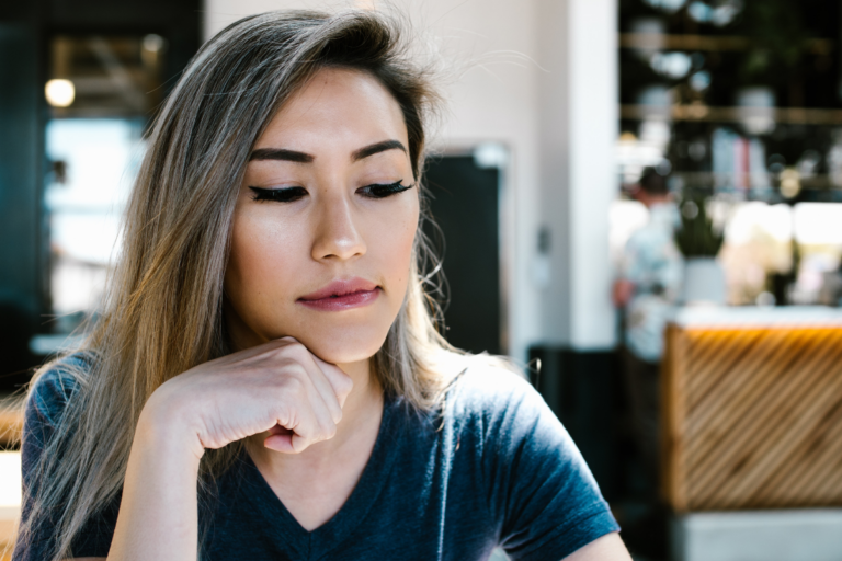 young-woman-looking-down-thinking-moody-reading