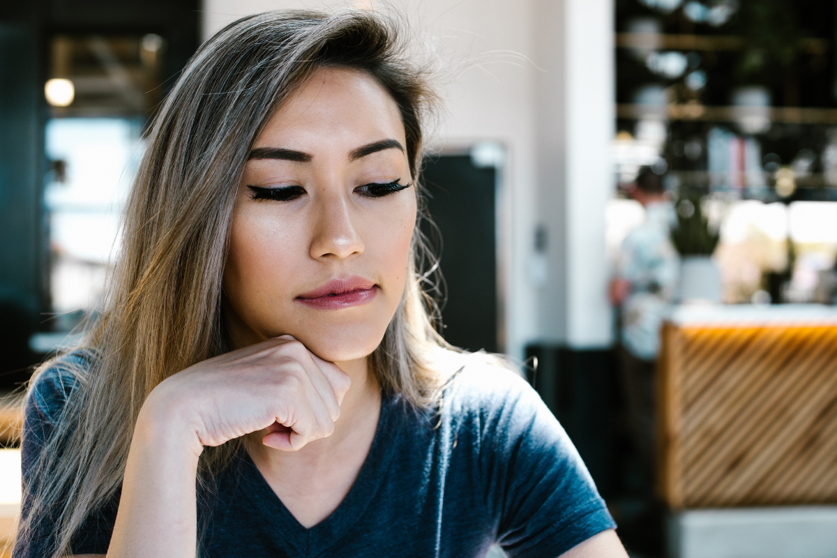young-woman-looking-down-thinking-moody-reading